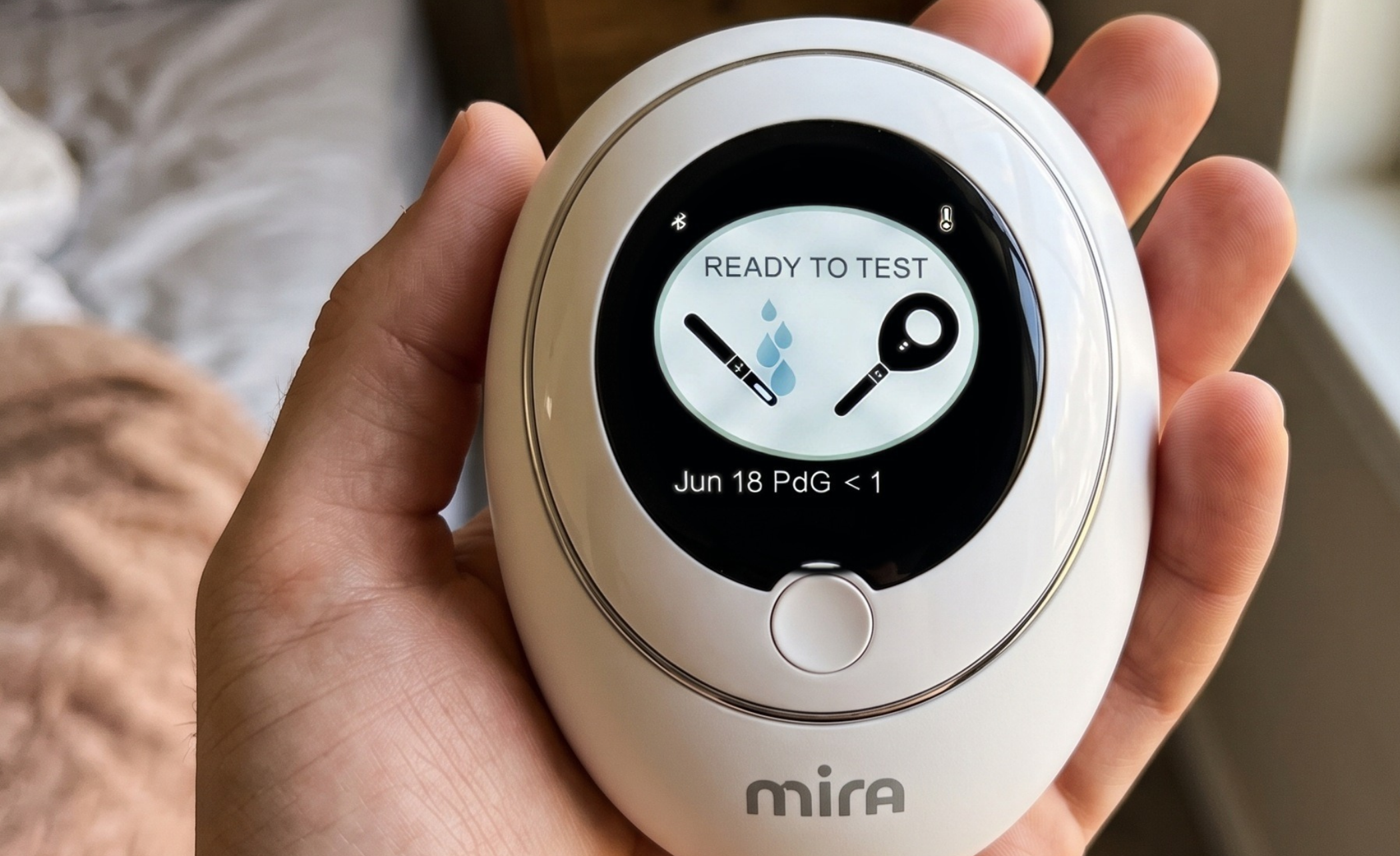 Hand holding the Mira hormone monitor